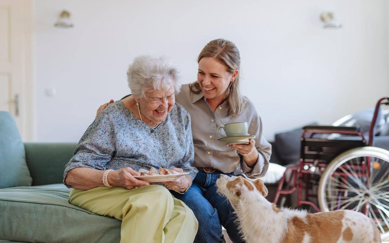 Frau betreut eine Seniorin in ihrer Wohnung